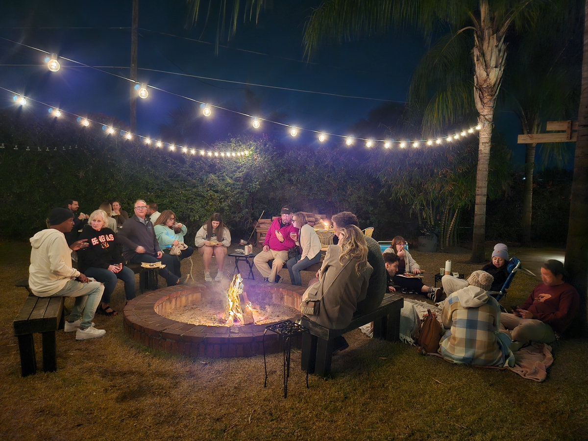 outdoor fire pit with people sitting on chairs